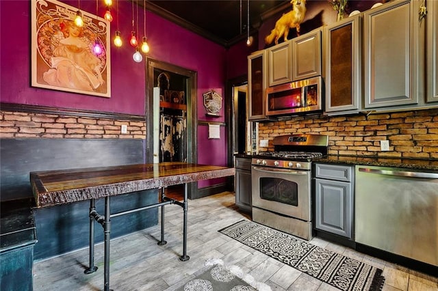 1421 Kentucky St, New Orleans, LA 70117 - kitchen with stainless steel appliances, ornamental molding, dark countertops, and decorative backsplash