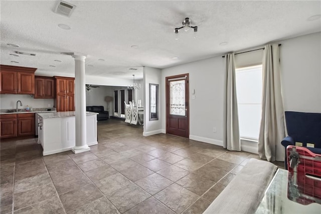 624 Taylorbrook St, Gretna, LA 70053 - foyer with ornate columns and a textured ceiling