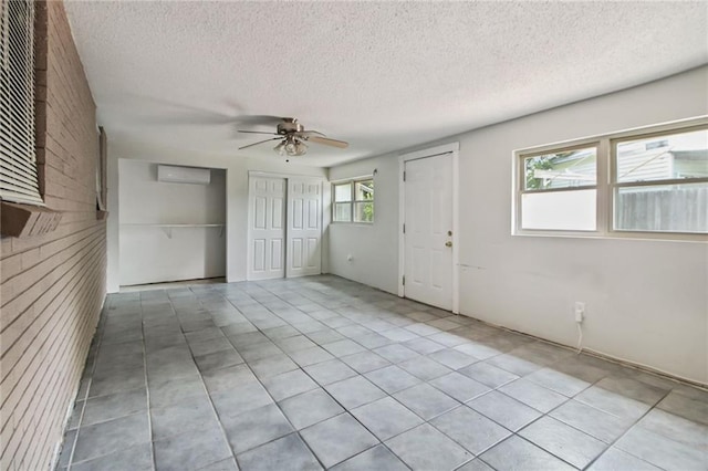 624 Taylorbrook St, Gretna, LA 70053 - foyer featuring a ceiling fan, a textured ceiling, a wall unit AC, and tile patterned flooring