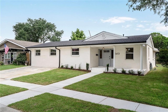5613 Morton St, Metairie, LA 70003 - ranch-style house with a front yard, brick siding, and driveway