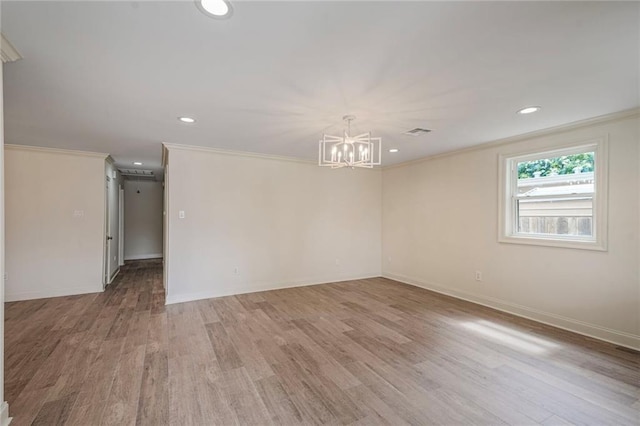 5613 Morton St, Metairie, LA 70003 - spare room with light wood finished floors, ornamental molding, a chandelier, and recessed lighting