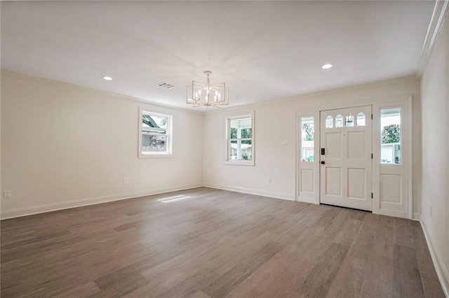 5613 Morton St, Metairie, LA 70003 - foyer entrance featuring ornamental molding, a chandelier, wood finished floors, and recessed lighting