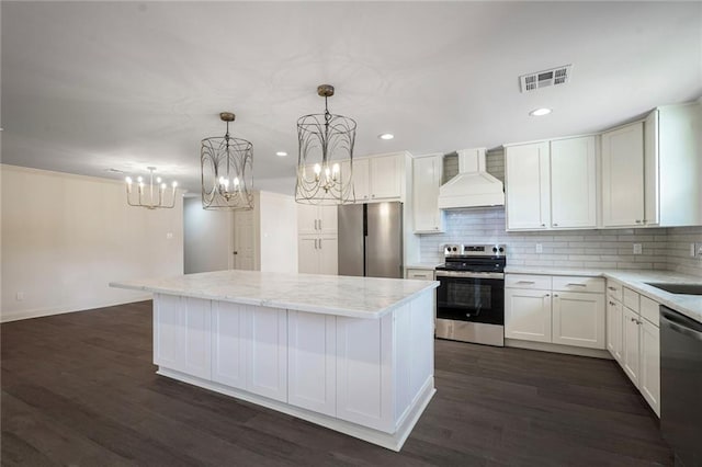 5613 Morton St, Metairie, LA 70003 - kitchen featuring custom exhaust hood, appliances with stainless steel finishes, a center island, decorative backsplash, and a chandelier