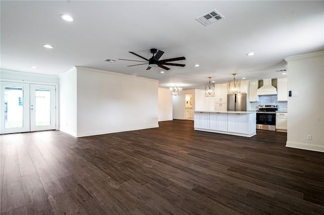 5613 Morton St, Metairie, LA 70003 - unfurnished living room with ceiling fan, dark wood-style floors, recessed lighting, crown molding, and a chandelier