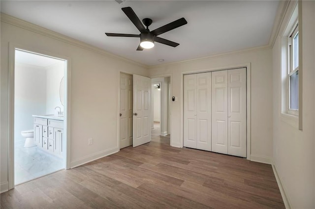 5613 Morton St, Metairie, LA 70003 - unfurnished bedroom featuring wood finished floors, connected bathroom, a closet, ornamental molding, and ceiling fan