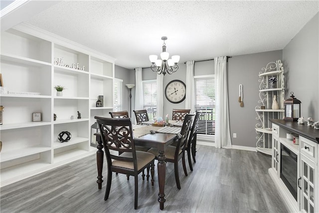 1927 Wyndemere Dr, Slidell, LA 70461 - dining area with a textured ceiling, a chandelier, dark wood-style flooring, and built in features