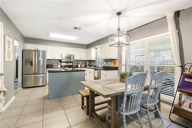 1927 Wyndemere Dr, Slidell, LA 70461 - dining area with a chandelier, plenty of natural light, and light tile patterned floors