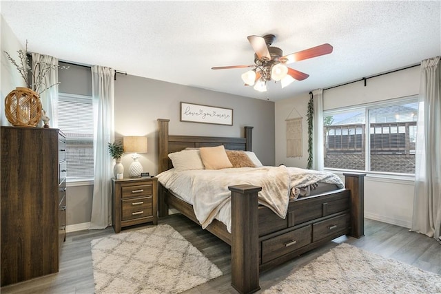 1927 Wyndemere Dr, Slidell, LA 70461 - bedroom with a textured ceiling, wood finished floors, and a ceiling fan