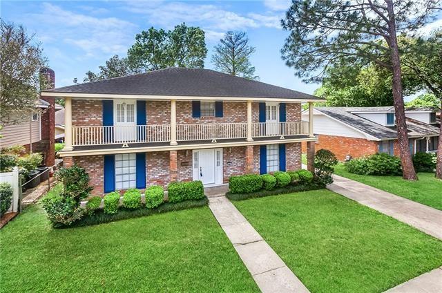 3757 Mimosa Ct, New Orleans, LA 70131 - view of front property featuring a balcony, brick siding, and a chimney