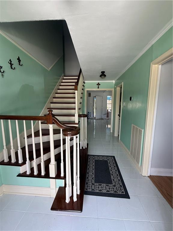 3757 Mimosa Ct, New Orleans, LA 70131 - stairs featuring tile patterned floors and ornamental molding