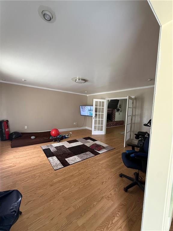3757 Mimosa Ct, New Orleans, LA 70131 - workout area with french doors, ornamental molding, and wood finished floors