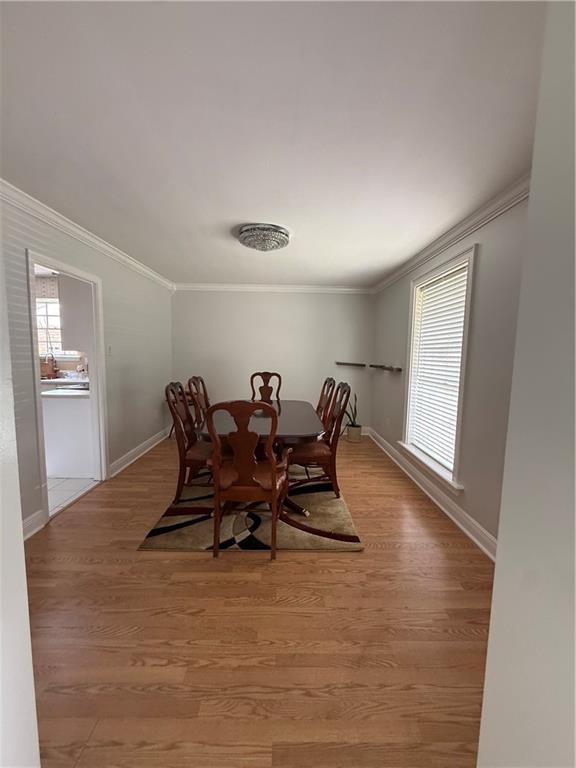 3757 Mimosa Ct, New Orleans, LA 70131 - dining room featuring ornamental molding, light wood-type flooring, and healthy amount of natural light