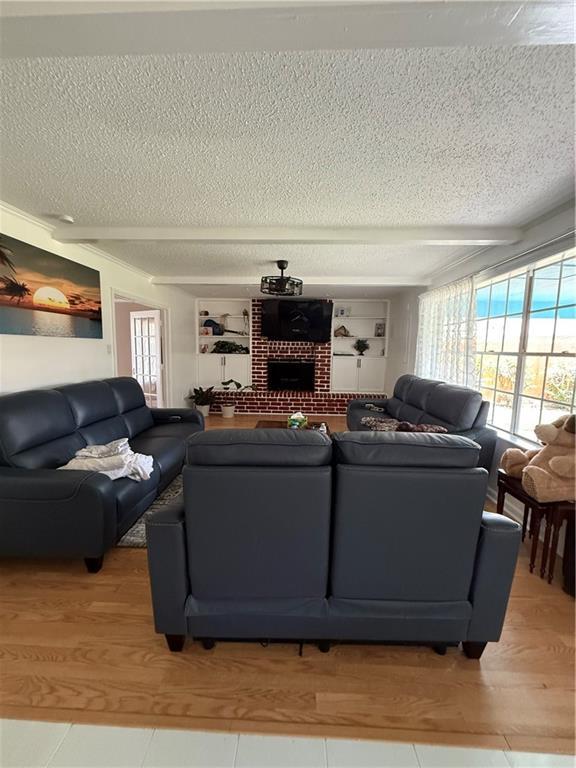 3757 Mimosa Ct, New Orleans, LA 70131 - living room with a textured ceiling and a brick fireplace