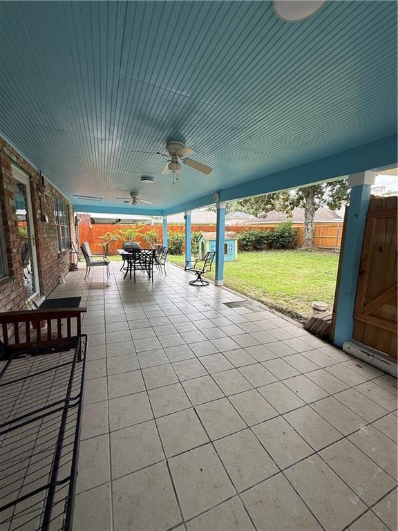 3757 Mimosa Ct, New Orleans, LA 70131 - fenced backyard featuring outdoor dining space, a ceiling fan, and a patio