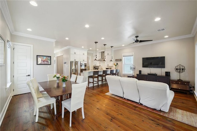 819 Franklin Ave, New Orleans, LA 70117 - dining space with a ceiling fan, dark wood-type flooring, recessed lighting, and crown molding