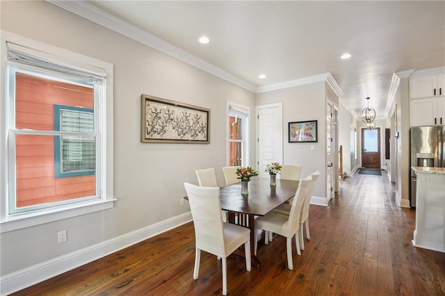 819 Franklin Ave, New Orleans, LA 70117 - dining room featuring dark wood-type flooring, a chandelier, plenty of natural light, crown molding, and recessed lighting