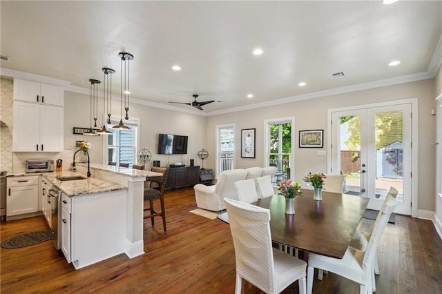 819 Franklin Ave, New Orleans, LA 70117 - dining space featuring dark wood-style flooring, recessed lighting, crown molding, french doors, and ceiling fan