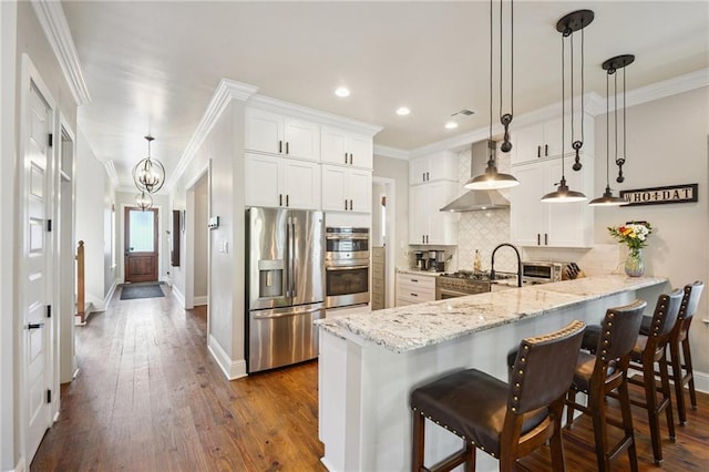 819 Franklin Ave, New Orleans, LA 70117 - kitchen with stainless steel appliances, recessed lighting, dark wood-type flooring, a peninsula, and backsplash