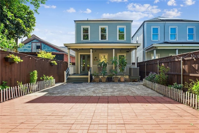 819 Franklin Ave, New Orleans, LA 70117 - view of front facade with covered porch, a fenced backyard, and a patio