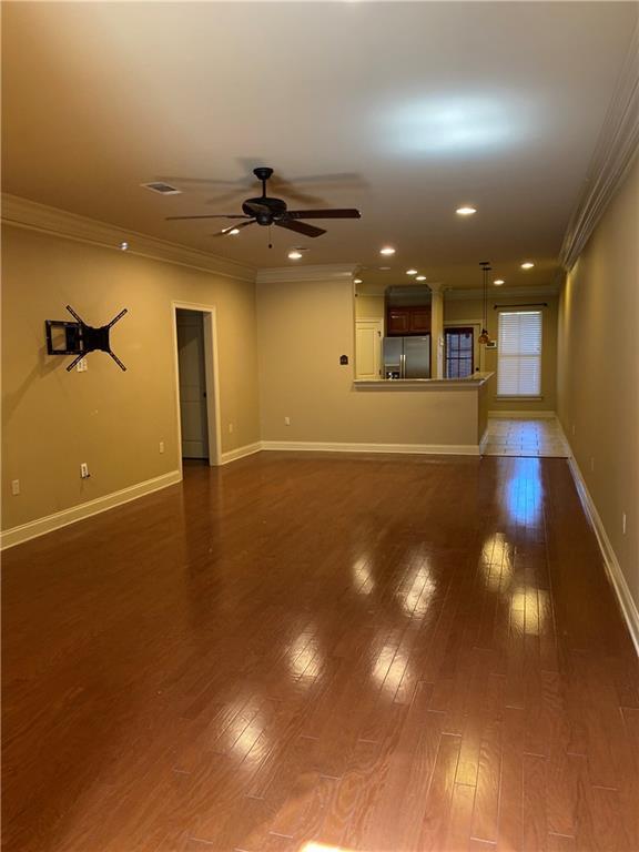 11110 Boardwalk Dr Unit 41, Baton Rouge, LA 70816 - unfurnished living room with crown molding, a ceiling fan, dark wood-style flooring, and recessed lighting