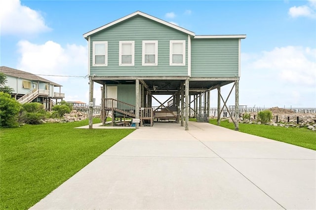 271 Lakeview Dr, Slidell, LA 70458 - beach home with a front lawn, a carport, driveway, and stairway