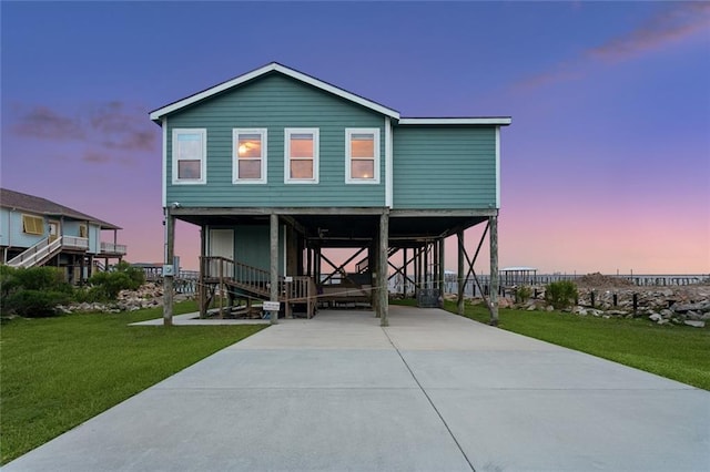 271 Lakeview Dr, Slidell, LA 70458 - coastal inspired home with a carport, a yard, concrete driveway, and stairway
