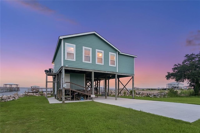 271 Lakeview Dr, Slidell, LA 70458 - rear view of property with a lawn, stairway, and a water view
