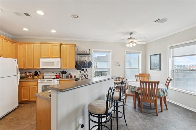 271 Lakeview Dr, Slidell, LA 70458 - kitchen with white appliances, a kitchen island, crown molding, a breakfast bar area, and light brown cabinetry