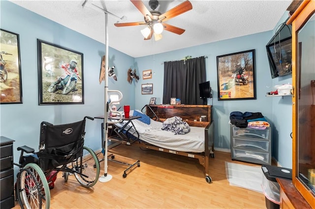 1799 Kings Row, Slidell, LA 70461 - bedroom featuring wood finished floors, a textured ceiling, and a ceiling fan