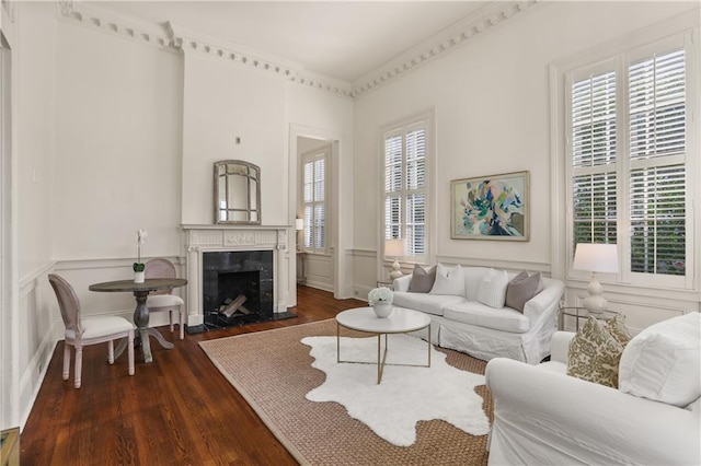 3325 Coliseum St, New Orleans, LA 70115 - living area with a decorative wall, dark wood-type flooring, a wainscoted wall, and a premium fireplace
