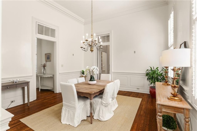 3325 Coliseum St, New Orleans, LA 70115 - dining area with crown molding, dark wood-type flooring, a chandelier, a decorative wall, and plenty of natural light