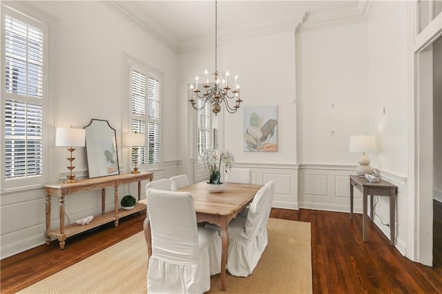 3325 Coliseum St, New Orleans, LA 70115 - dining room featuring a chandelier, dark wood-style floors, crown molding, a decorative wall, and a wainscoted wall