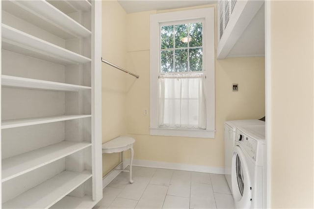 3325 Coliseum St, New Orleans, LA 70115 - laundry room featuring light tile patterned floors and independent washer and dryer