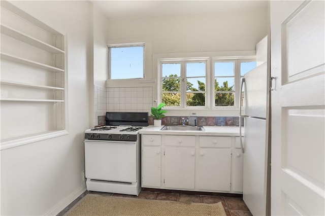 3325 Coliseum St, New Orleans, LA 70115 - kitchen with white appliances, white cabinets, light countertops, decorative backsplash, and open shelves