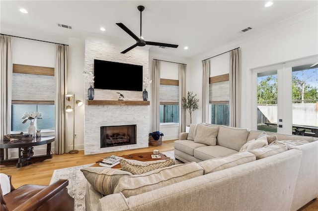 1185 Delta Ln, Covington, LA 70433 - living area with ceiling fan, a stone fireplace, wood finished floors, and recessed lighting