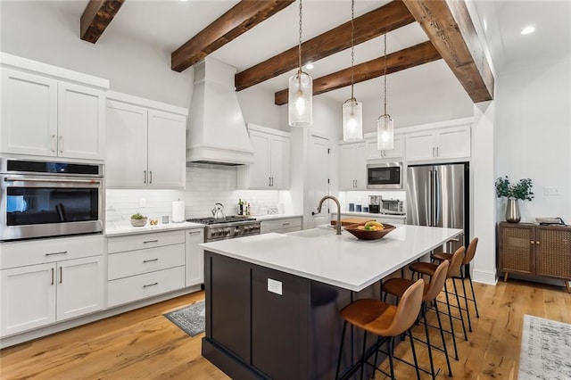 1185 Delta Ln, Covington, LA 70433 - kitchen featuring appliances with stainless steel finishes, custom range hood, backsplash, light countertops, and white cabinets