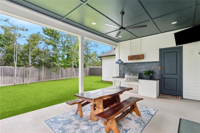 1185 Delta Ln, Covington, LA 70433 - fenced backyard featuring an outdoor kitchen, outdoor dining area, ceiling fan, and a patio area
