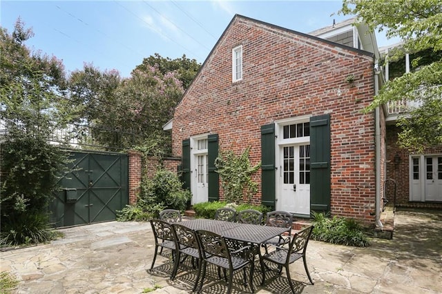 1124 Barracks St, New Orleans, LA 70116 - view of patio featuring outdoor dining area and a garage