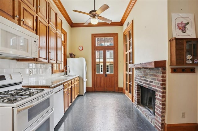 1124 Barracks St, New Orleans, LA 70116 - kitchen featuring white appliances, ornamental molding, backsplash, brown cabinets, and a ceiling fan