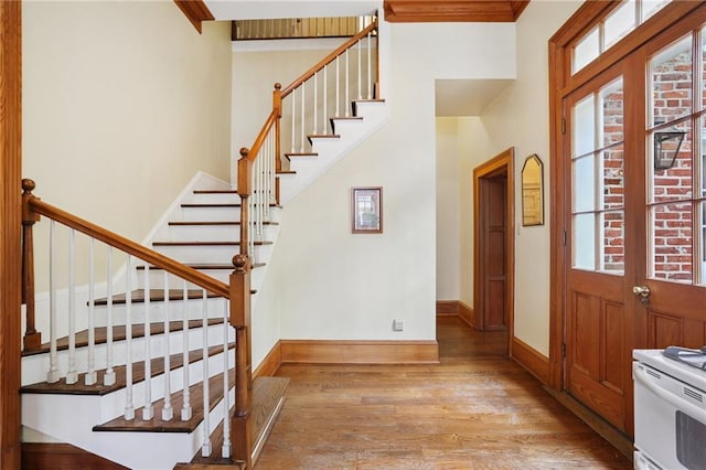 1124 Barracks St, New Orleans, LA 70116 - foyer with light wood finished floors, stairway, and a towering ceiling