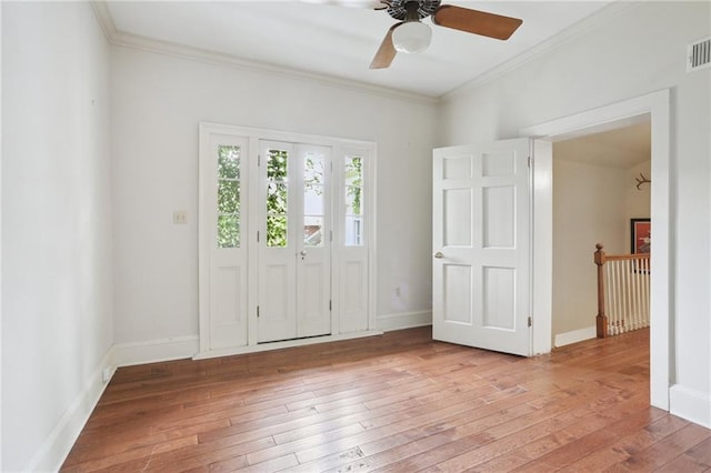 1124 Barracks St, New Orleans, LA 70116 - entrance foyer with wood-type flooring, crown molding, and a ceiling fan
