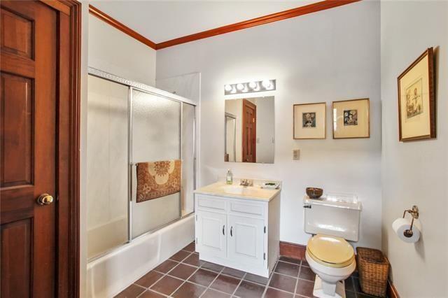 1124 Barracks St, New Orleans, LA 70116 - full bath with vanity, crown molding, tile patterned flooring, and combined bath / shower with glass door