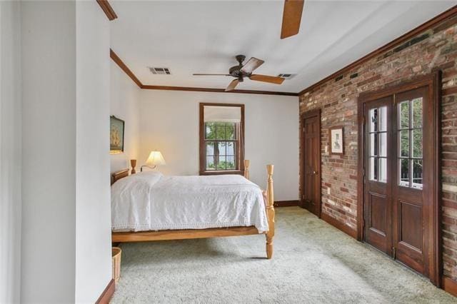 1124 Barracks St, New Orleans, LA 70116 - carpeted bedroom featuring brick wall, crown molding, multiple windows, and ceiling fan