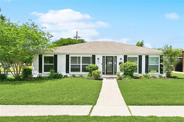 4400 Cleveland Pl, Metairie, LA 70003 - view of front of home with a front lawn, brick siding, and a shingled roof
