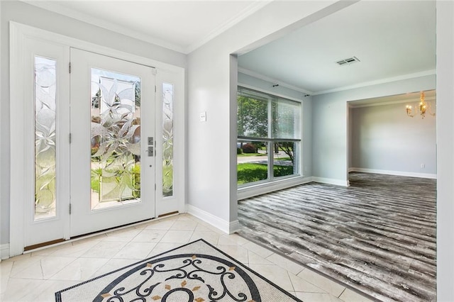 4400 Cleveland Pl, Metairie, LA 70003 - tiled foyer entrance with a chandelier and ornamental molding