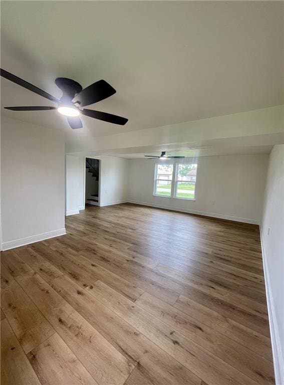 144 Yvonne Dr, Avondale, LA 70094 - unfurnished room featuring ceiling fan, wood-type flooring, and stairway