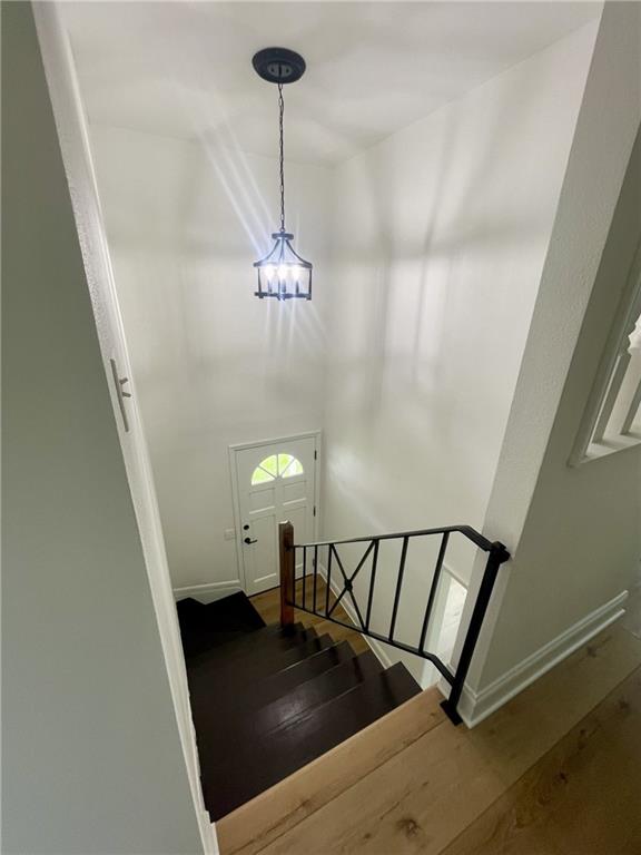 144 Yvonne Dr, Avondale, LA 70094 - staircase with a chandelier and wood finished floors