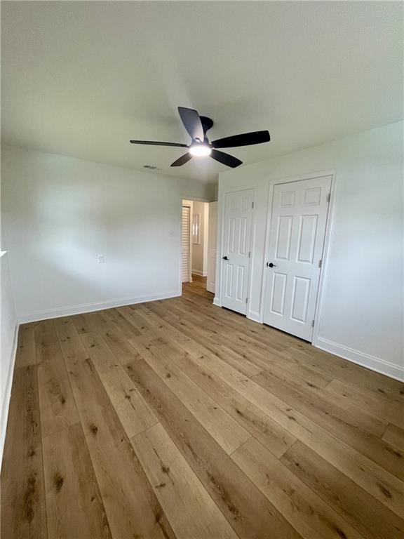 144 Yvonne Dr, Avondale, LA 70094 - unfurnished bedroom featuring hardwood / wood-style floors and ceiling fan