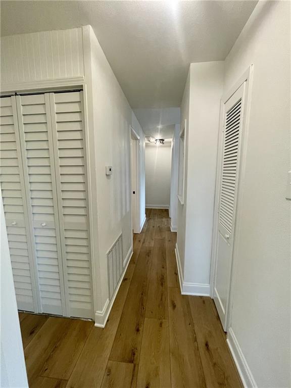 144 Yvonne Dr, Avondale, LA 70094 - hallway featuring hardwood / wood-style flooring and baseboards