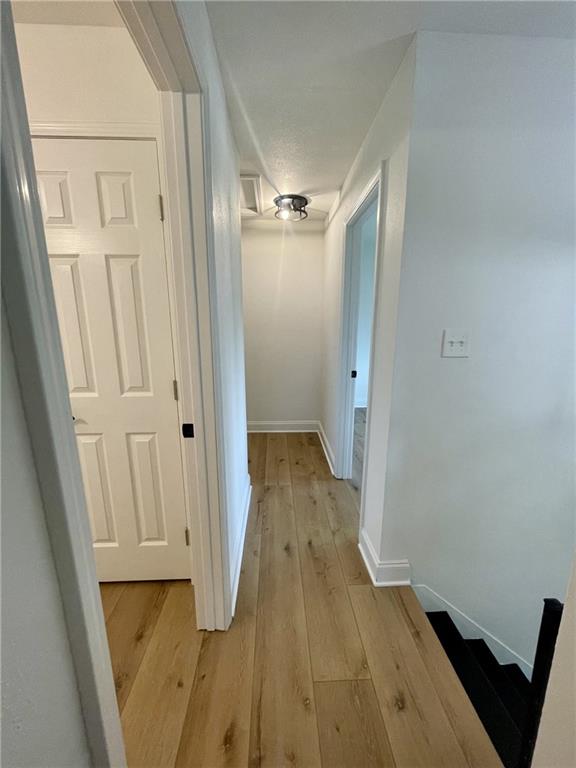 144 Yvonne Dr, Avondale, LA 70094 - hallway with light wood-style flooring and baseboards